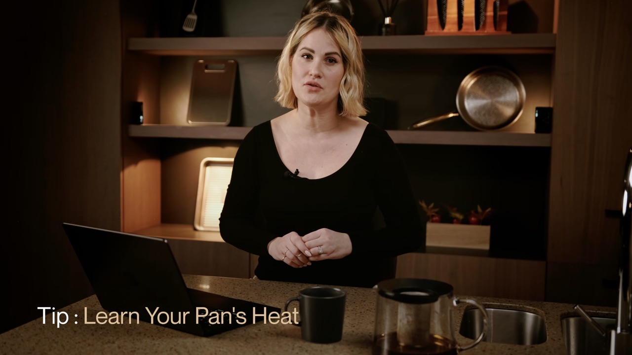 Presenter explaining pan heat in a Taima cookware video